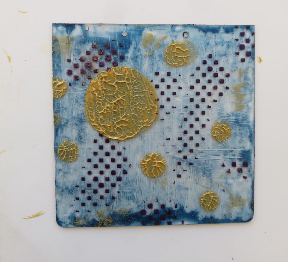 This is how the piece looks with all circles added and dry. Clean your knife over the page to add more gold paint between the circles.