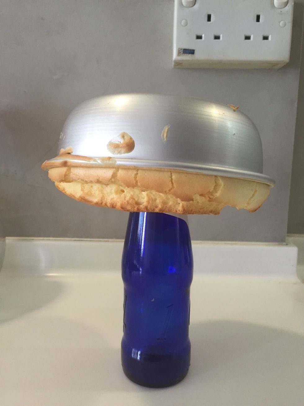 This is how u cool the cake down, on a bottle. When completely cool, run the side of the mold with a knife and gently shake the cake out.