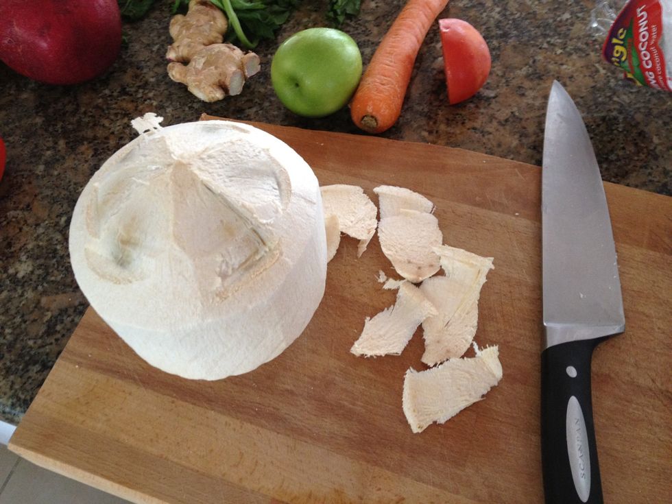 This is how you open up the coconut. First, cut off the first layer.