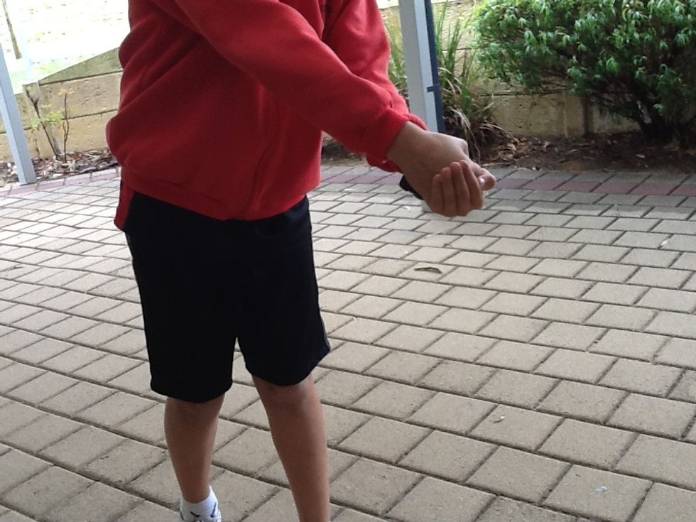 This is how your hands should be after you have hit the Football.