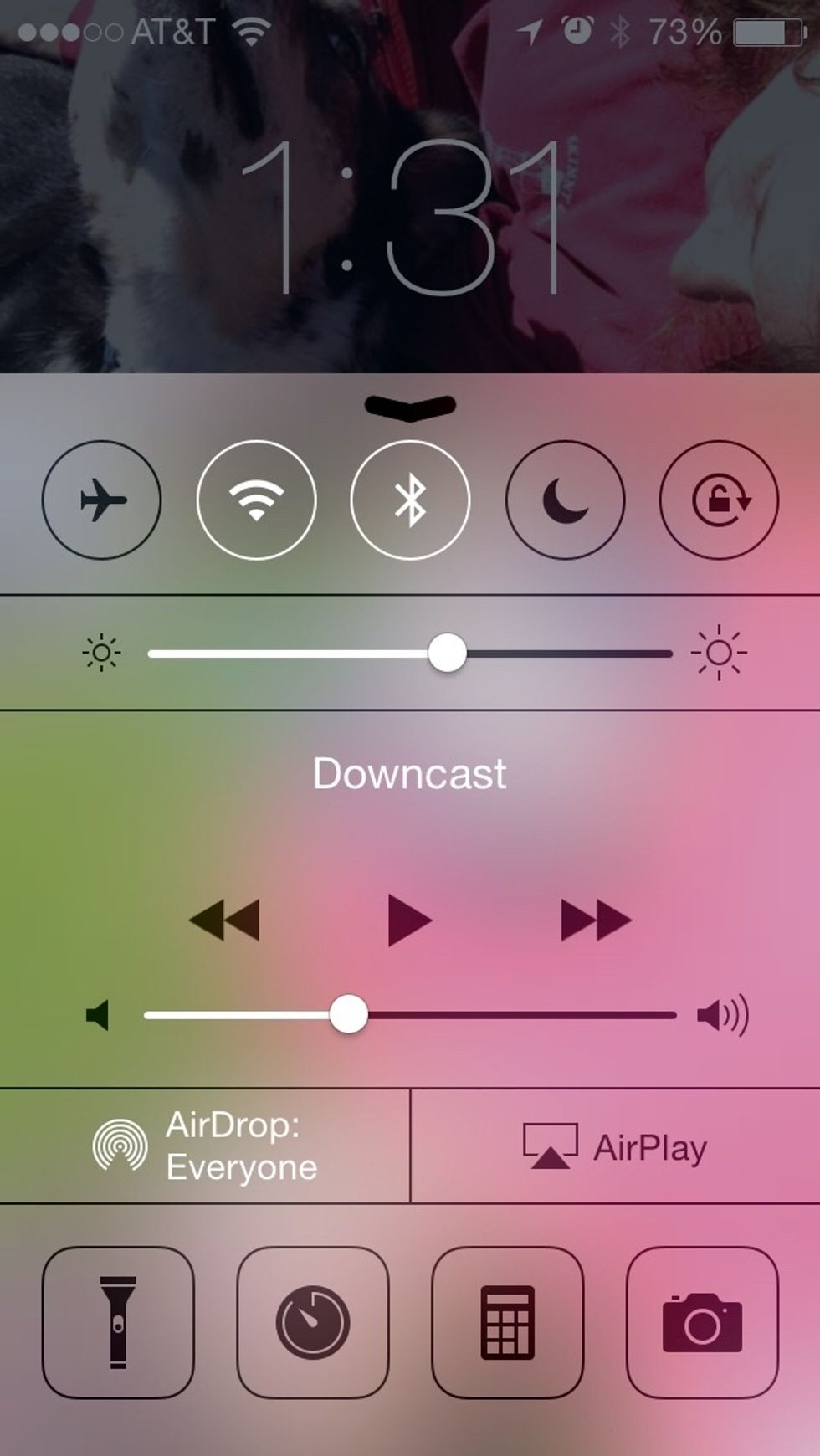 This is iOS 7. Note that the control center icons (like Wifi, Bluetooth, etc) are black when disabled and white when enabled.