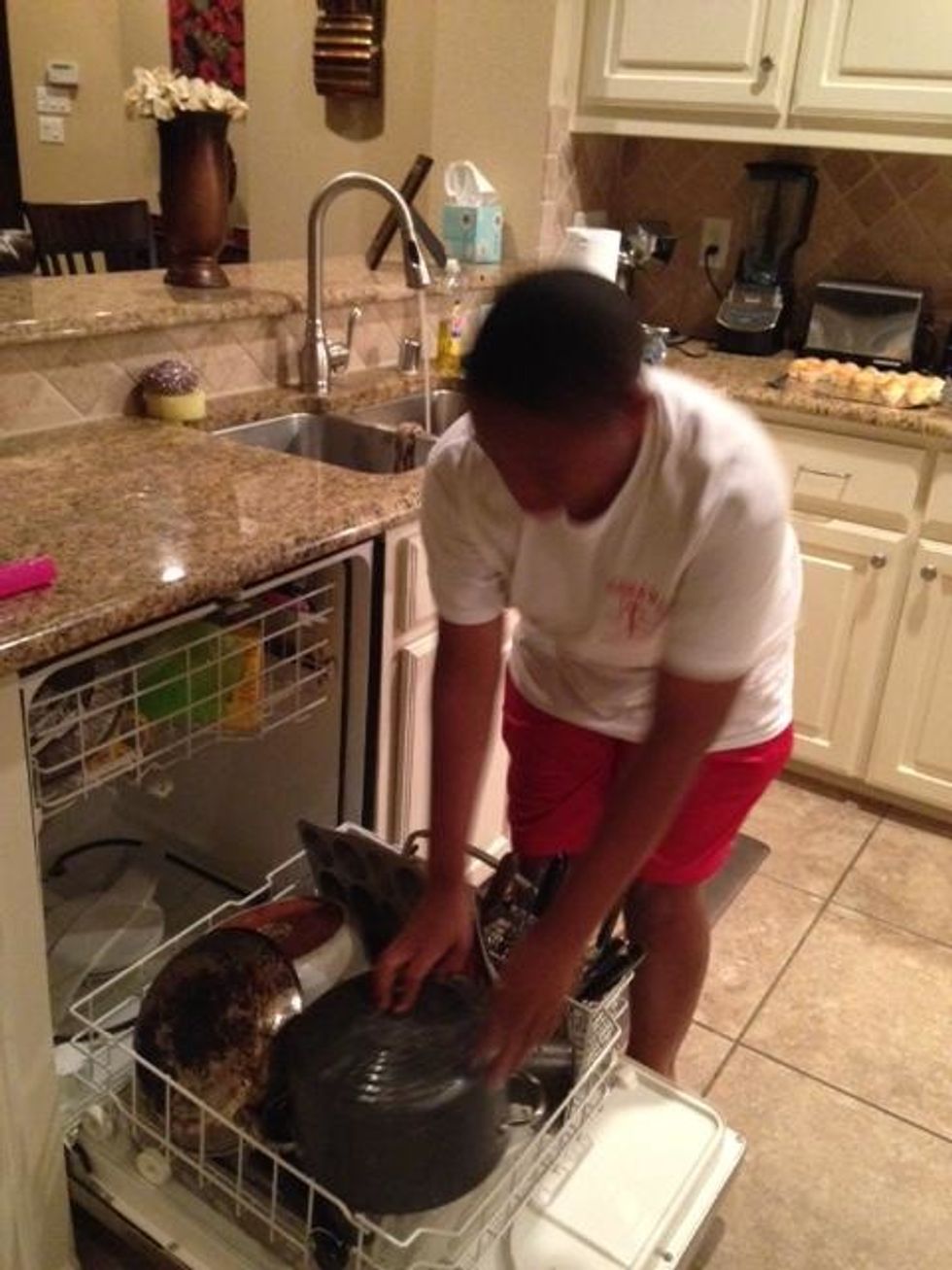 This is me putting the pots and pans in the dishwasher.