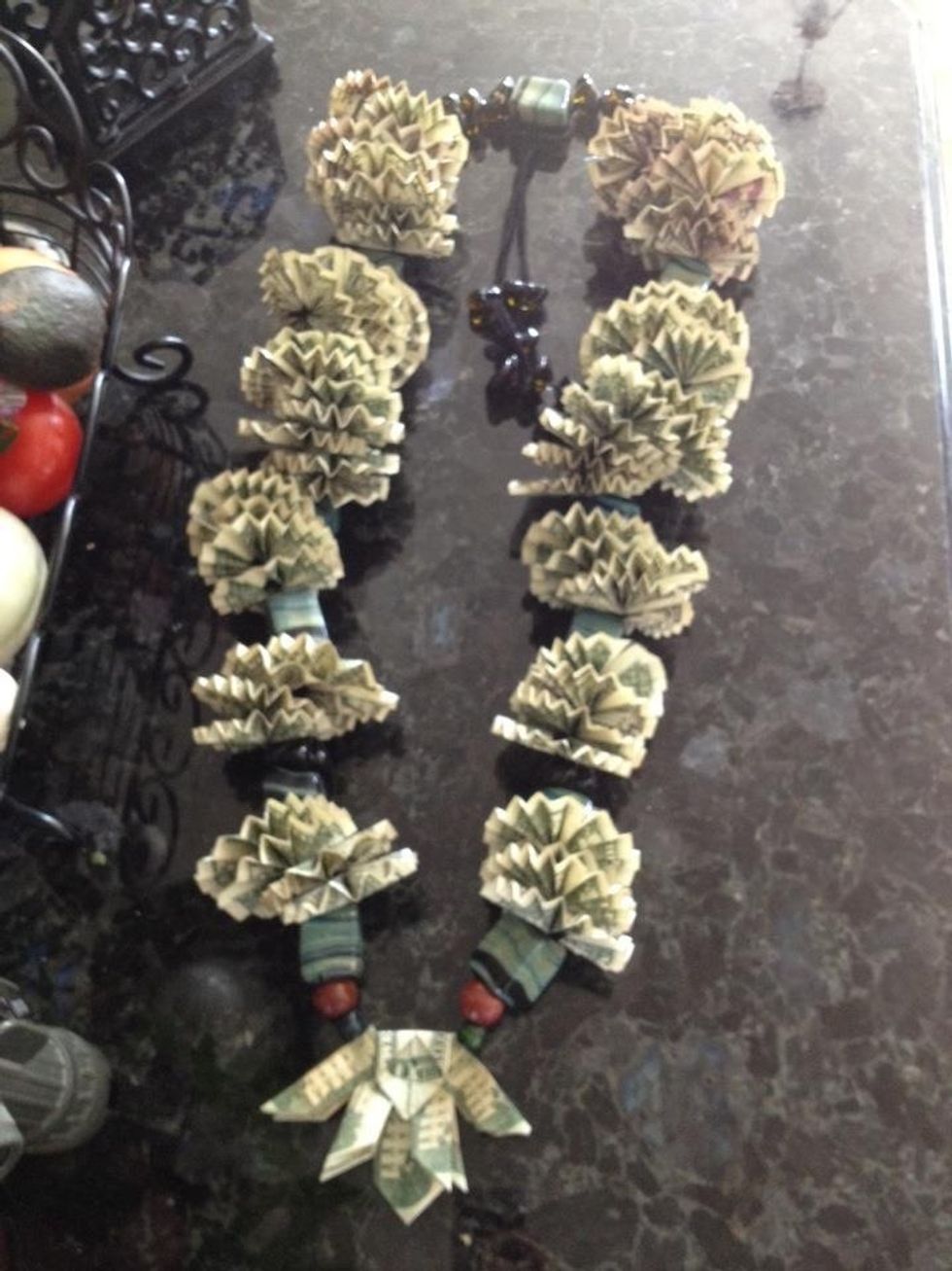 This is my finished lei.... Yes .. some people might want to just stick too the cheap wrapped leis since I used 250 worth... Lol It was for my bro I was really surprised he graduated lol