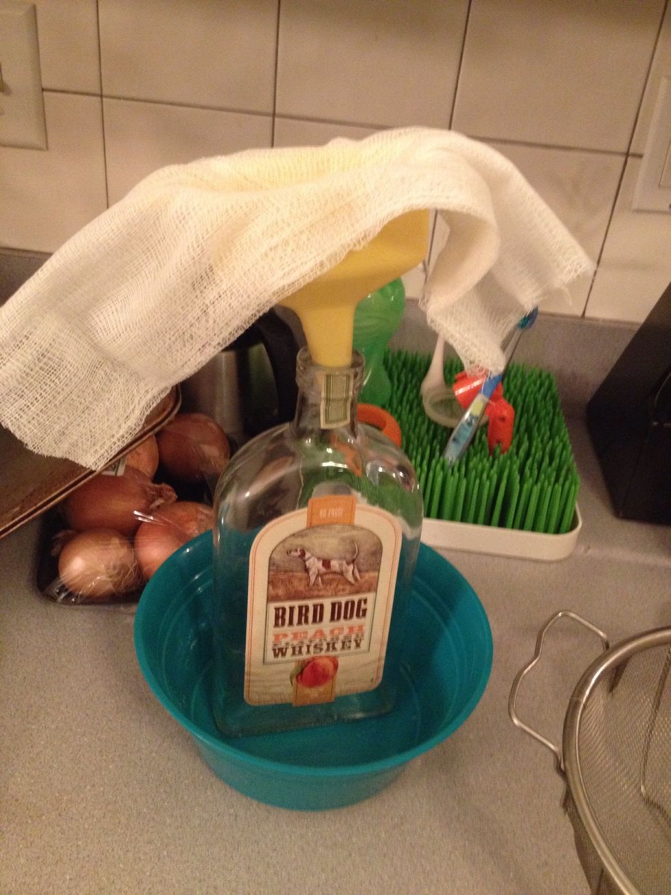 This is my set up for filtering the spices from the syrup. The cheesecloth is put into the filter and strains the spices into the bottle. The bowl catches any drips.