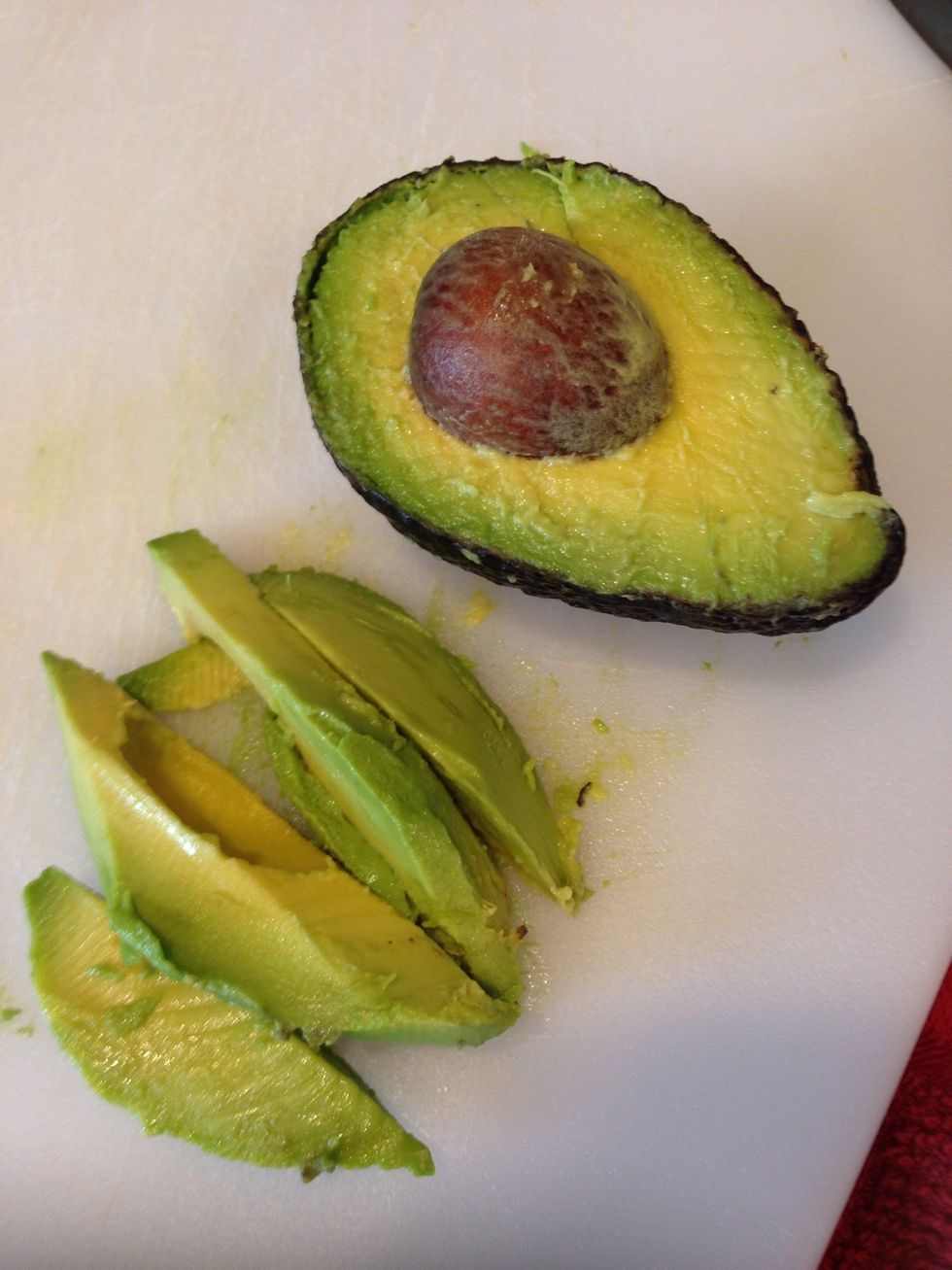 This is optional, I love avocados so I added it on. Take half of an avocado and cut into slices. Like so.