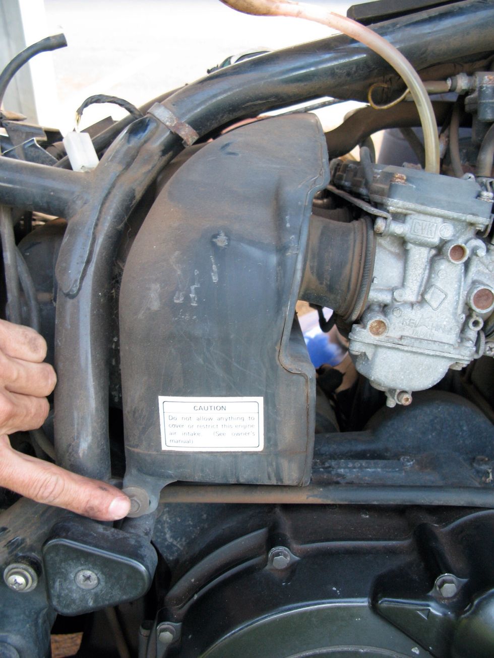 This is the air box. Two 10mm bolts and the carbs keep it trapped. You don't need to remove these, but I'm planning on getting rid of it in favor of 4 individual air filters