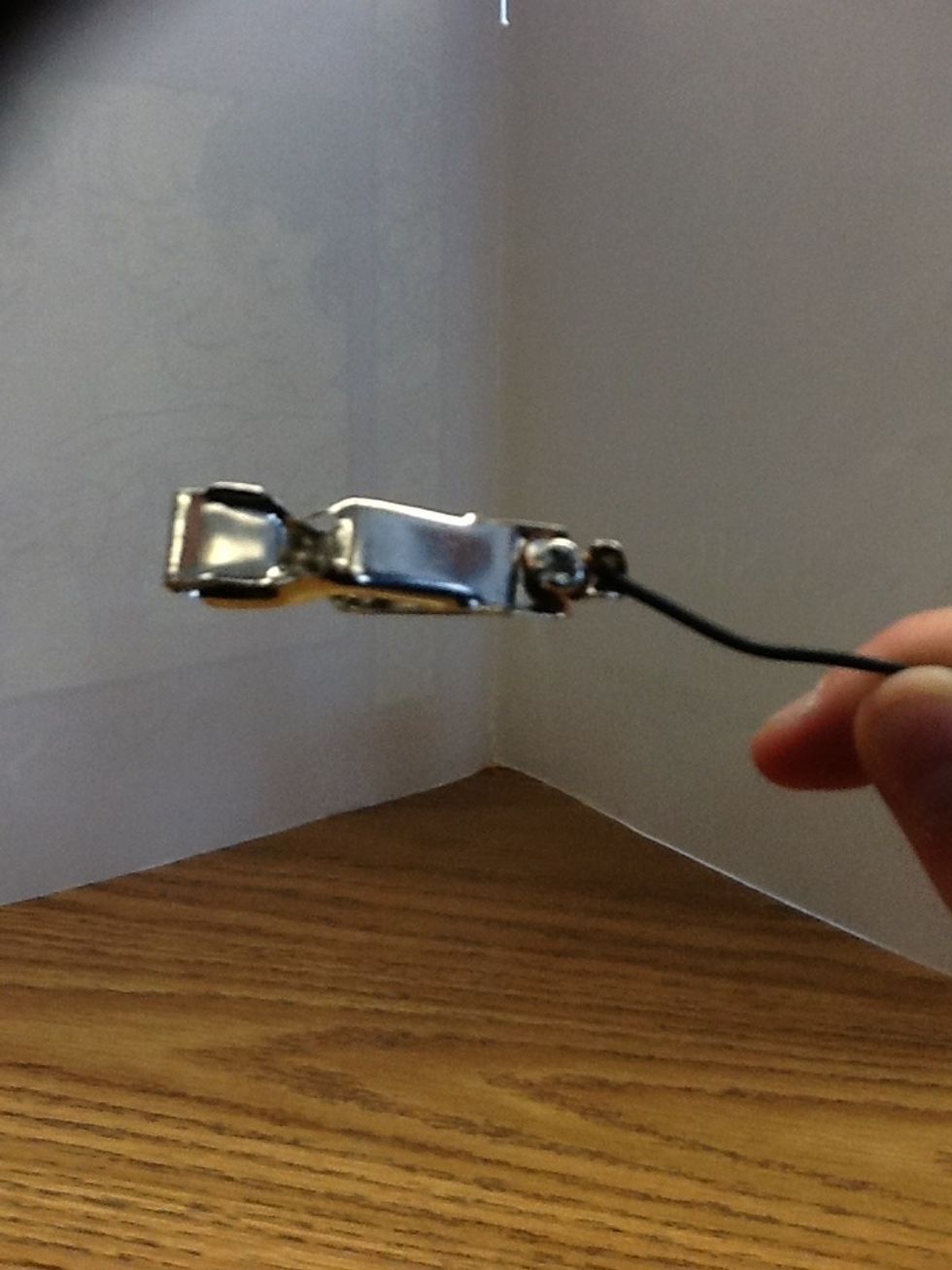 This is the alligator clip. As you can see the hooked wire is wrapped around the screw and leading through the opening of the alligator clip.