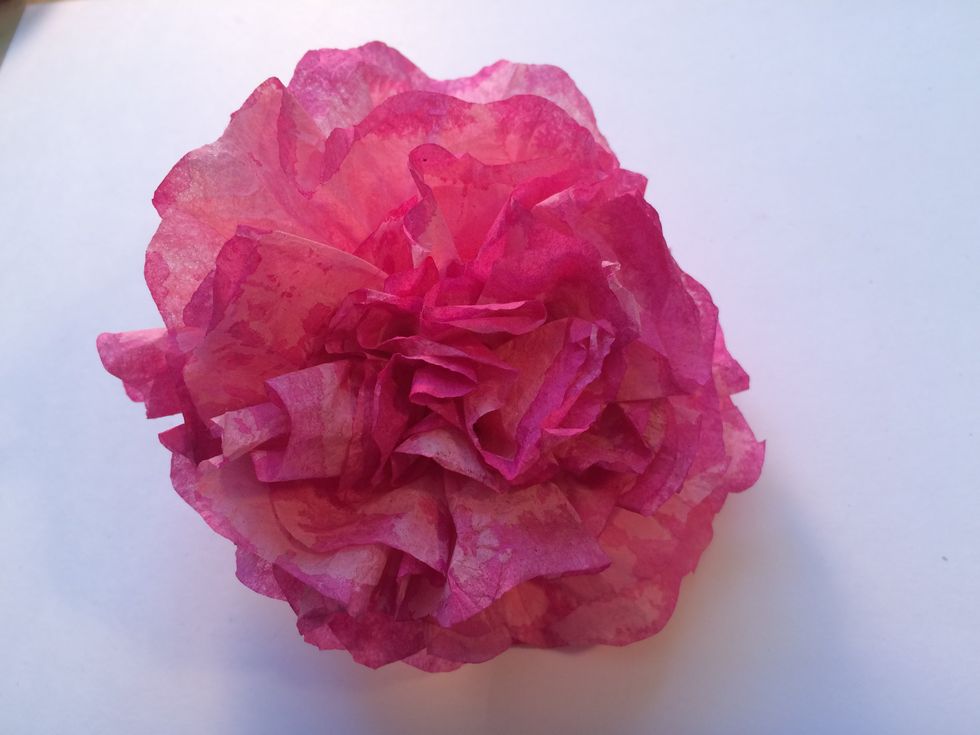 This is the completed flower. Fluff it up, scrunch in the petals until you have shaped it to your liking. Do this process with each of the colored filters you have made.