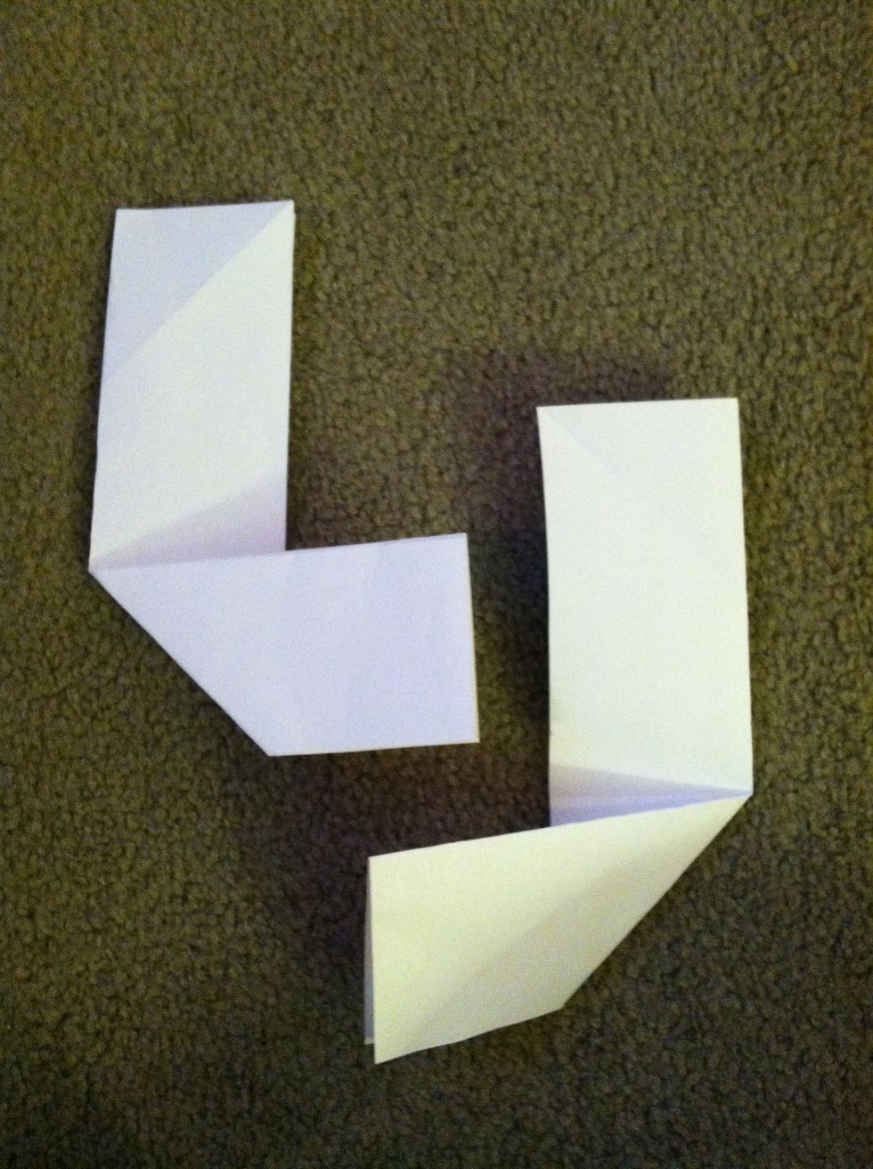 This is the difficult part. Take the bottom of the first one and fold it over to the right. Do the opposite for the next one, folding it to the left.