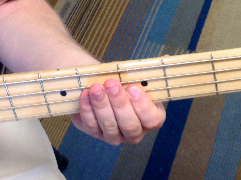 This is the fifth note in the scale, F. Place your finger between the second and third frets to play this note.