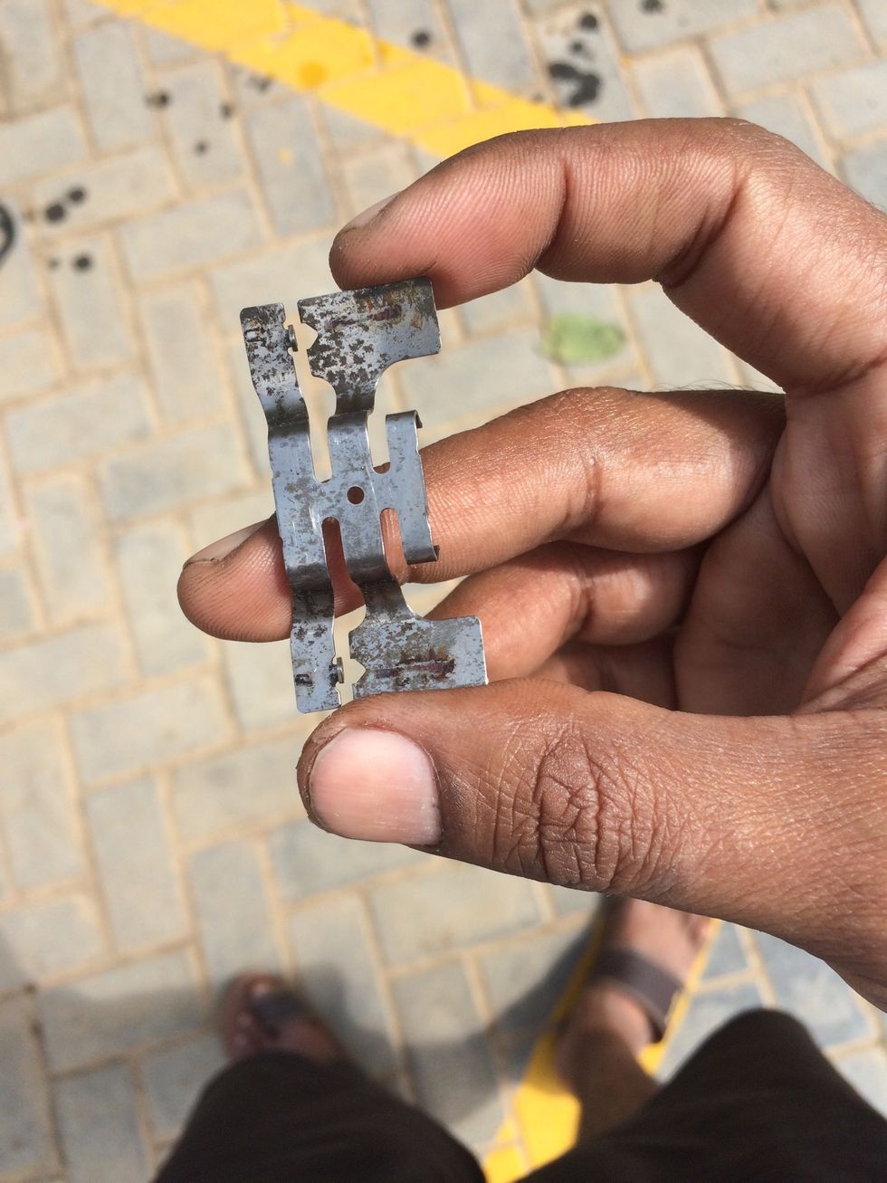 This is the flat spring that pushes the pad for alignment and retention