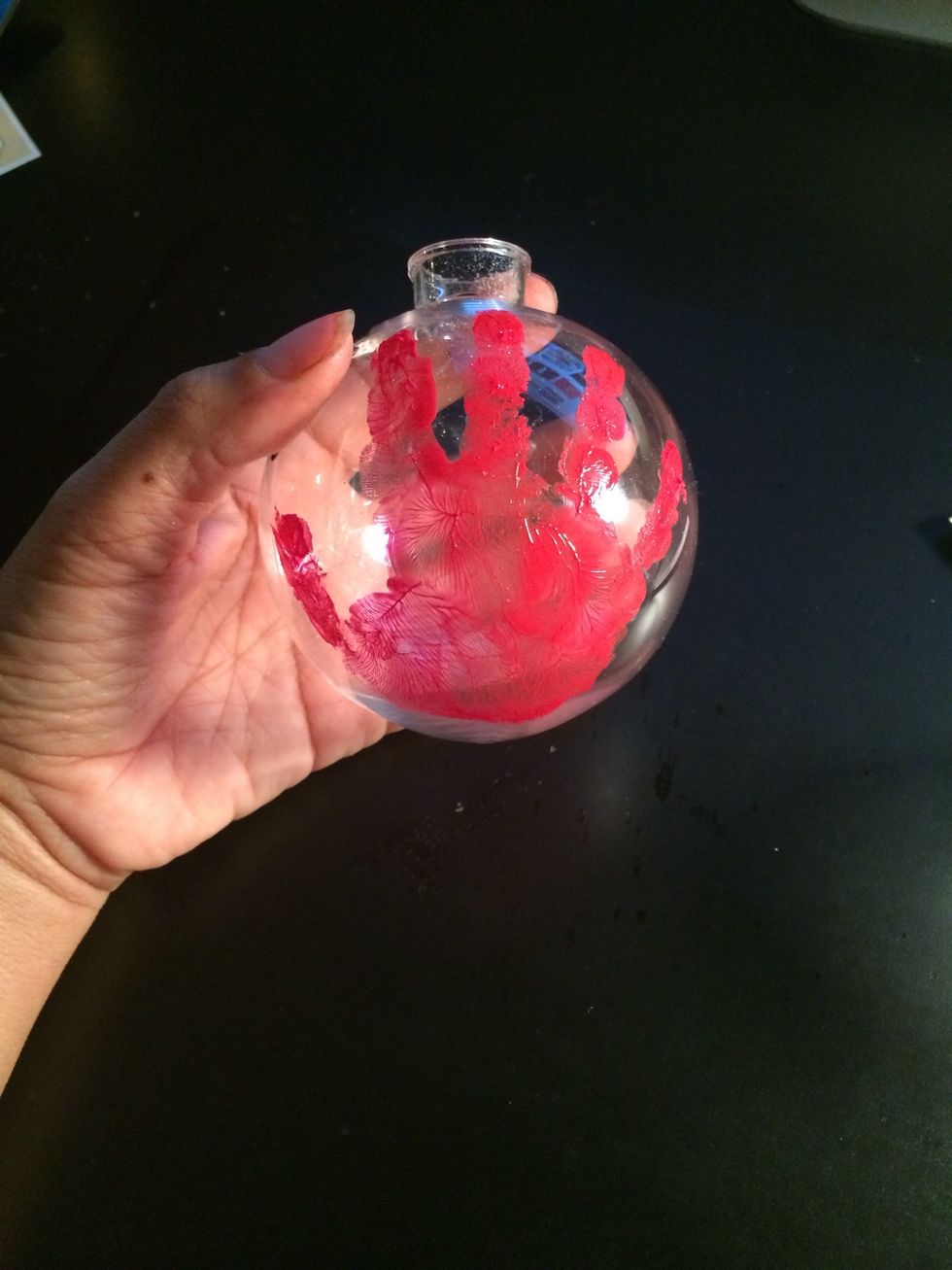 This is the fun part I took my sons hand and painted it with acrylic paint. I used a nice red color. I pressed it firmly on the ornament and allowed it to dry.