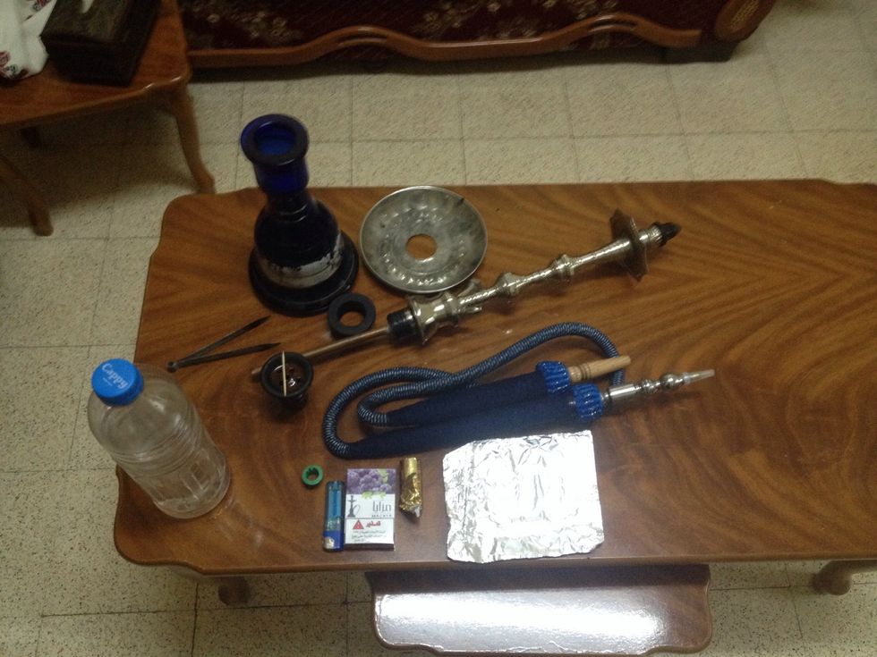 This is the hookah parts .. And a Piece of foil,toothpick,tobacco(am using blueberry flavor),lighter,water(H2O),coal(small size)