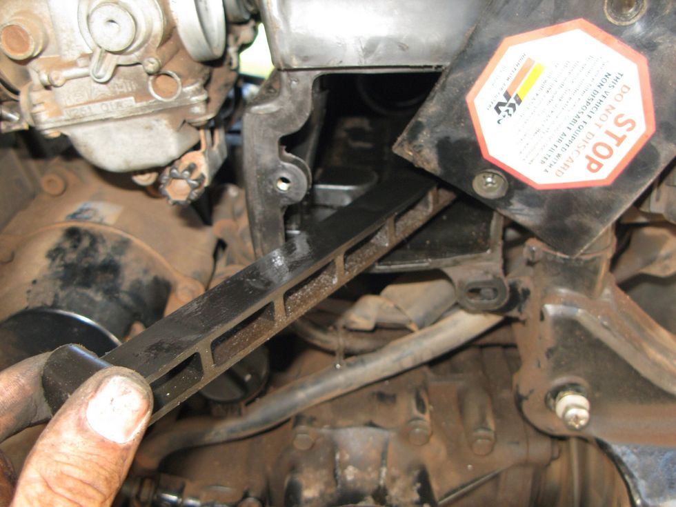 This is the inside of the air box. Remove these two screws. Pull this plastic wedge out then the air filter. Now you can pull from the inside as you push from the outside.