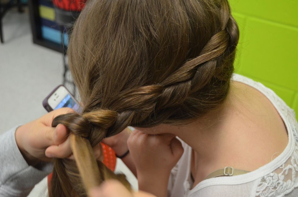 This is the last step of the braid. Finally pick up the rest of the hair and finish off the braid. Then secure it with an elastic hairband.
