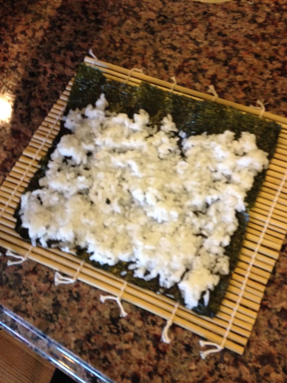 *This is the part kids love! With wet hands, plop a handful of rice onto the nori and carefully spread with a rice spatula only about 1/4" thick. Leave about 3/4" of an uncovered area at the top.