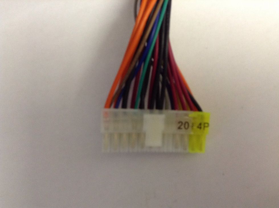 This is the plug we will be working with. Notice the different colour wires? Take note of the GREEN one (just to the left of the middle) and the BLACK ones.  We will use the black one to the far right