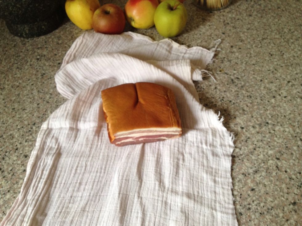 This is the smoked bacon I started using 3 weeks ago when I made bacon scones. Wrapping it in cloth keeps it fresh longer. The apples in the background are a reminder to me to use them soon.
