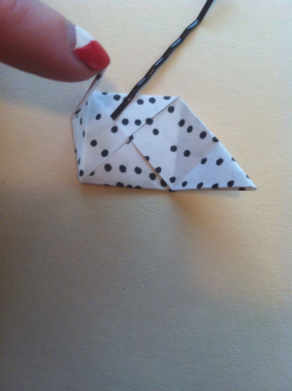 This is the tricky part. Careful not to rip pocket too much. Take bottom left tip & tuck into pocket where bobby pin is (see step 30 for an in process photo...helps to curl it).