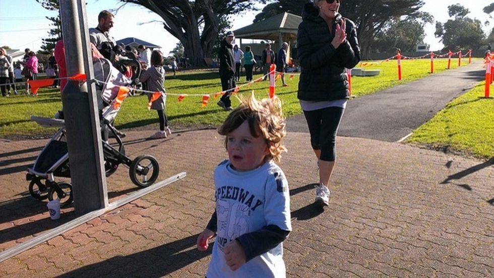 This is what it look looks like this little boy is have fun and he is running.