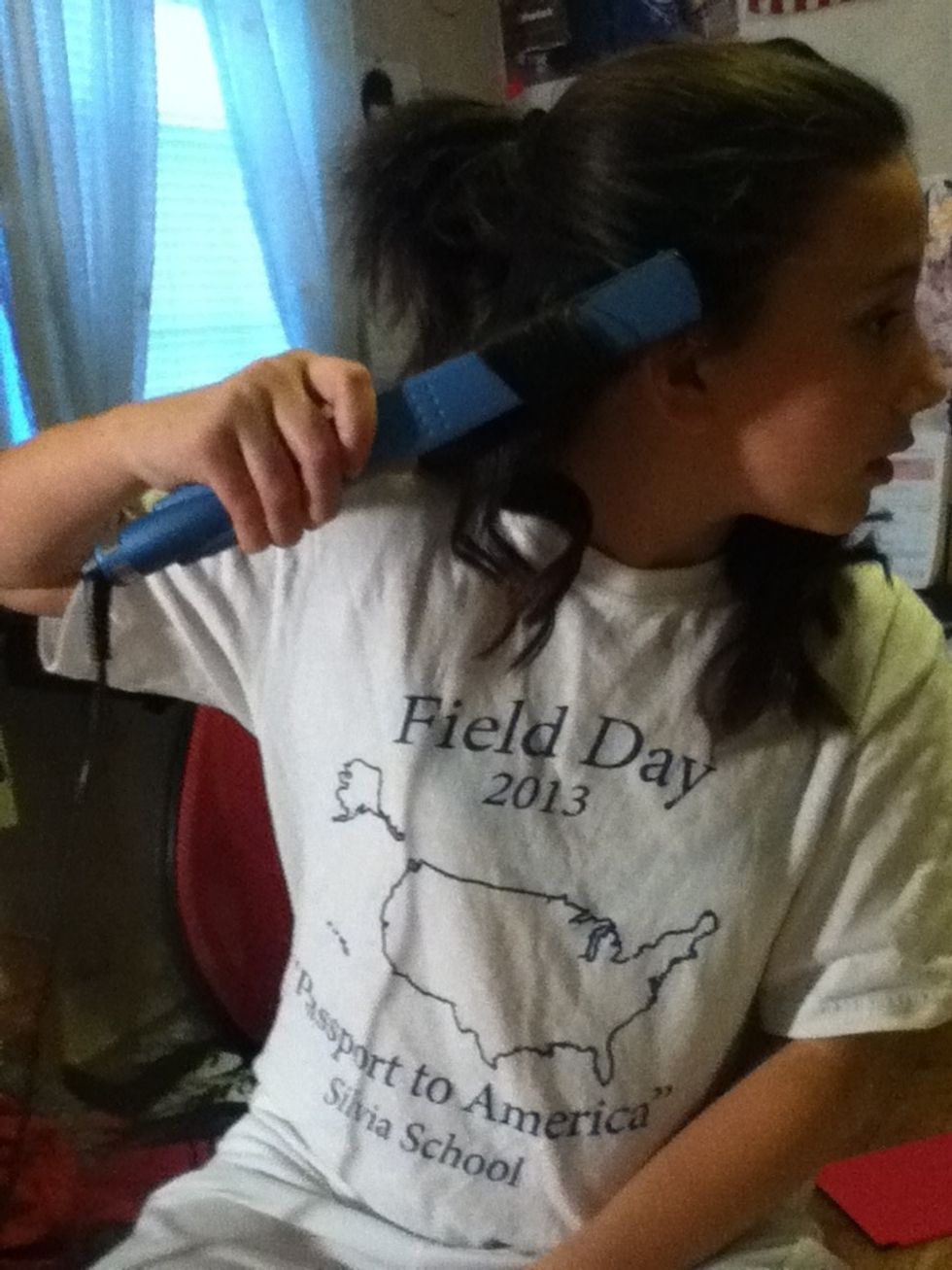 This is what it looks like when your hair is underneath your straightener now all you have to do is slowly pull down your straightener and release to get your curl and don't forget your second layer