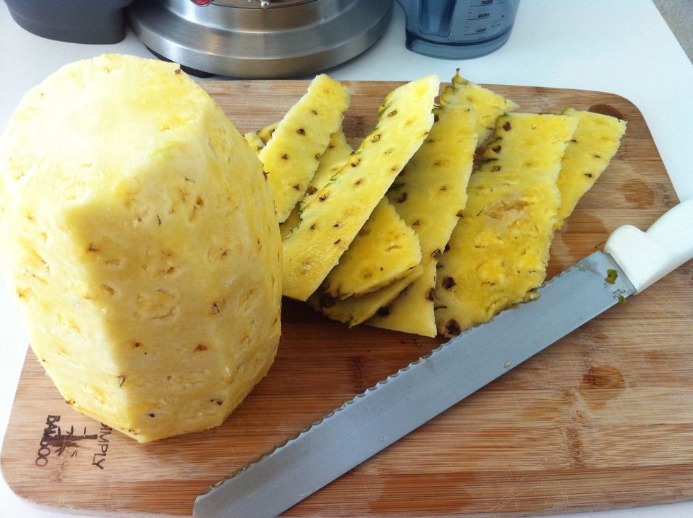 This is what it looks once you remove the rind. Now discard the rind and place the pineapple under running water to remove rind debris and prevent cross contamination. I wash the knife and board too.