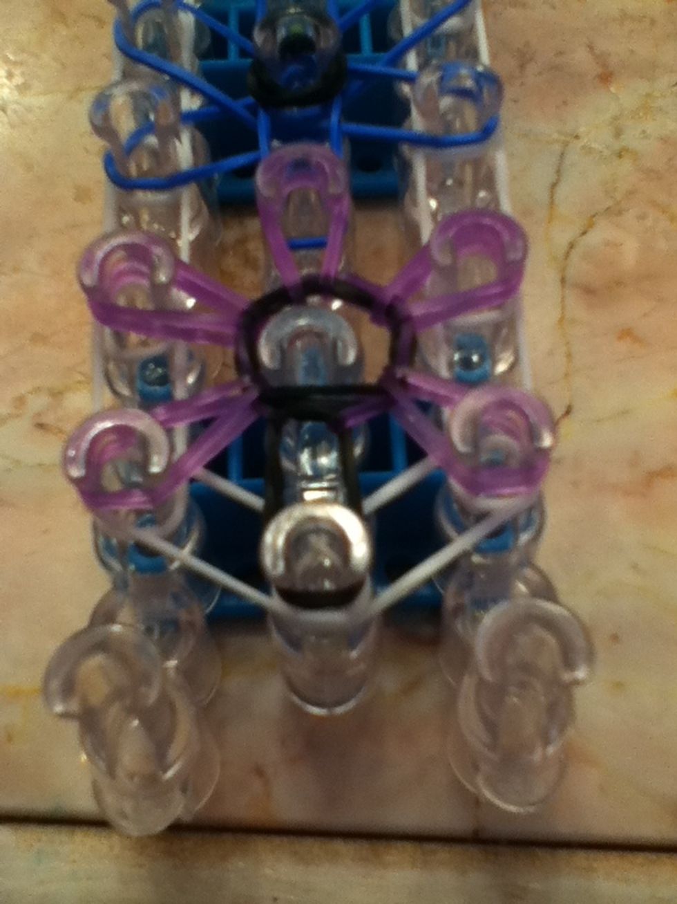 This is what it should look like. Do this for all the other colors until you get to the top. No bands should be on the middle peg.