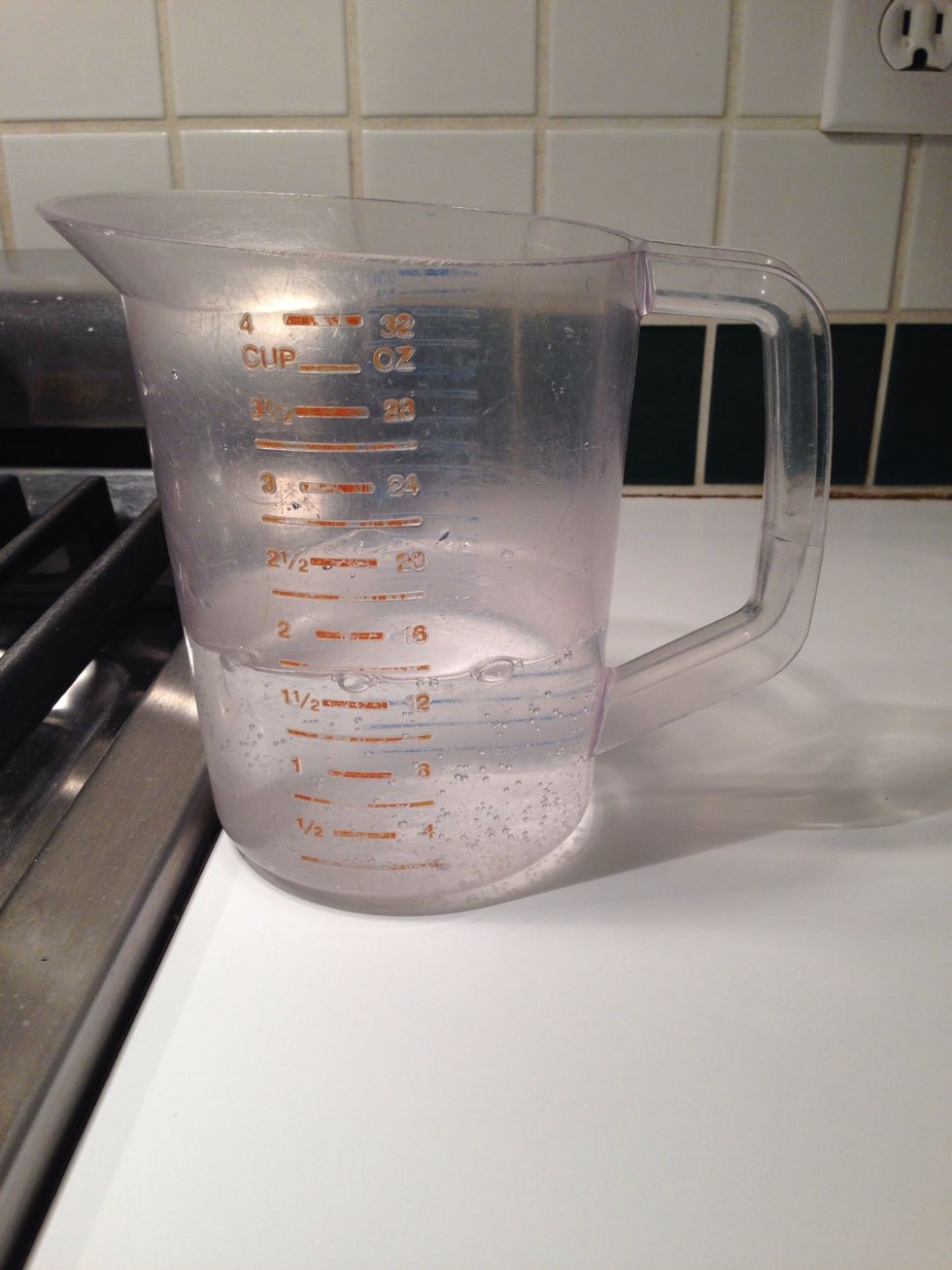 This is what measuring cups are for. Liquids! Pour 12 oz. of that fizzy water into the flour and yeast and mix it around. We're going to call this mix a "sponge" because that's what Nancy calls it.