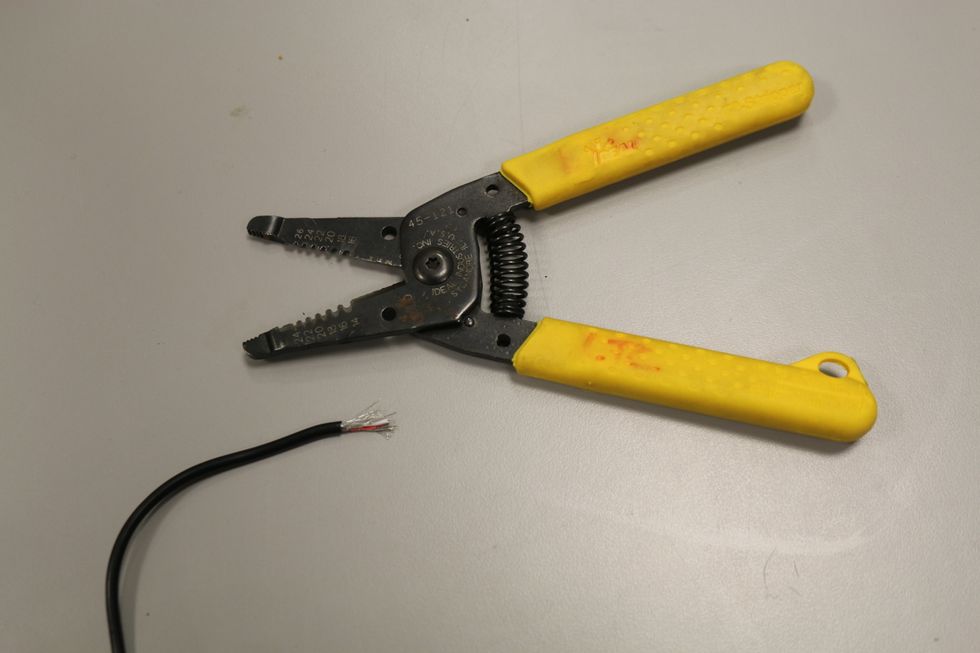 This is what mine looked like after completing the last step. Notice there are three different wires here (the metal wires already exposed, the white cord, and the red cord)