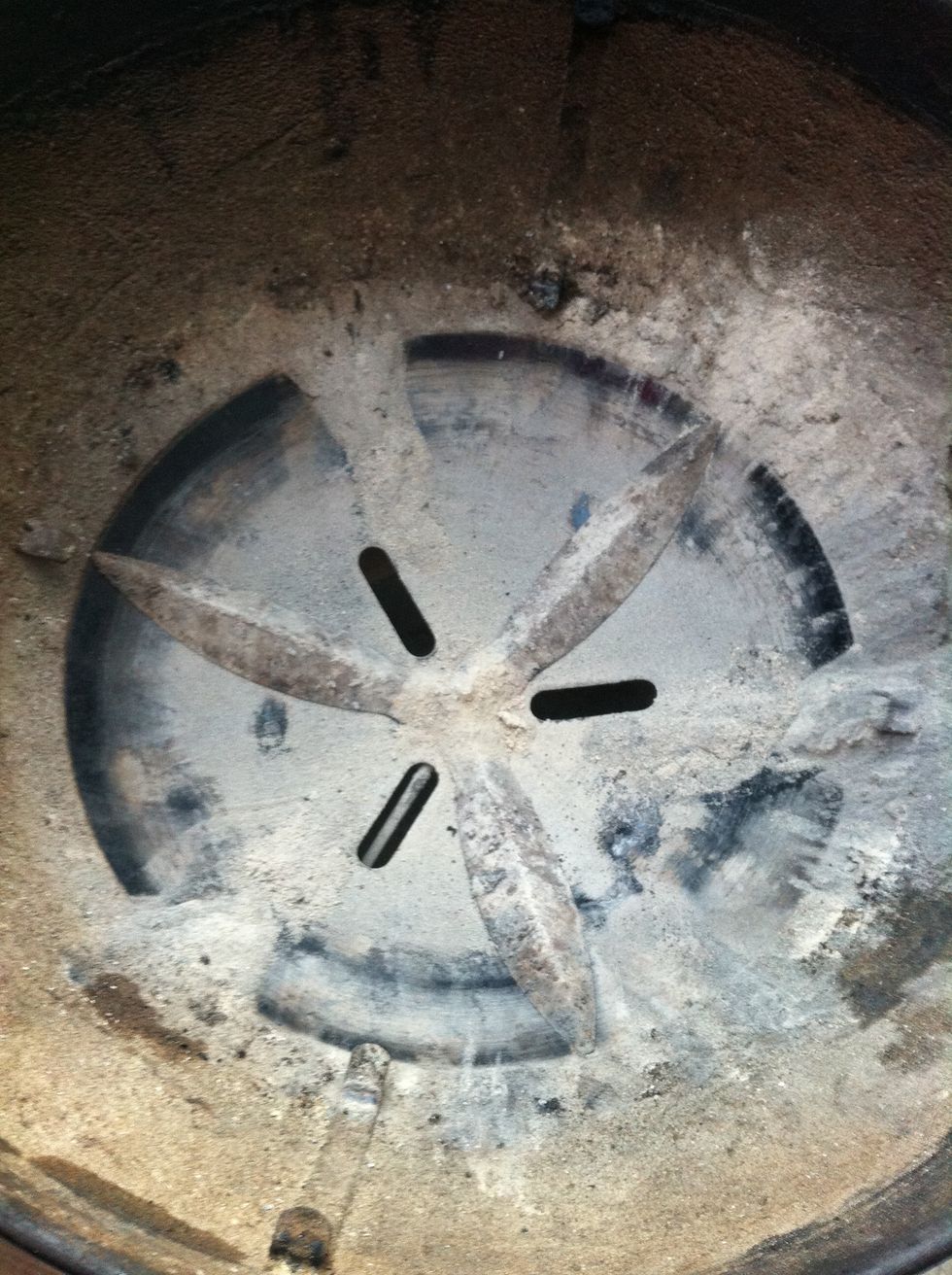 This is what the bottom of your grill should look like. Note the open vents - this is essential for airflow. The draft lights the briquettes, which makes for a nice, hot flame.