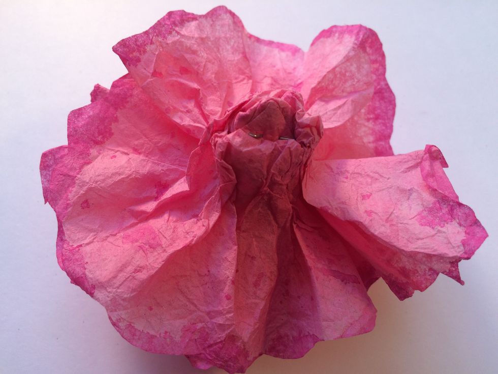 This is what the underneath of your flower should look like. Now grab some clear tape, and wrap it around that gathered part at the bottom to hold it all in place.