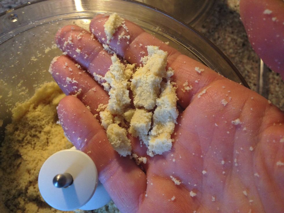 This is what you want. The oil in the almonds makes the flour stick together when pressed and turn back into flour when rubbed between your fingers.