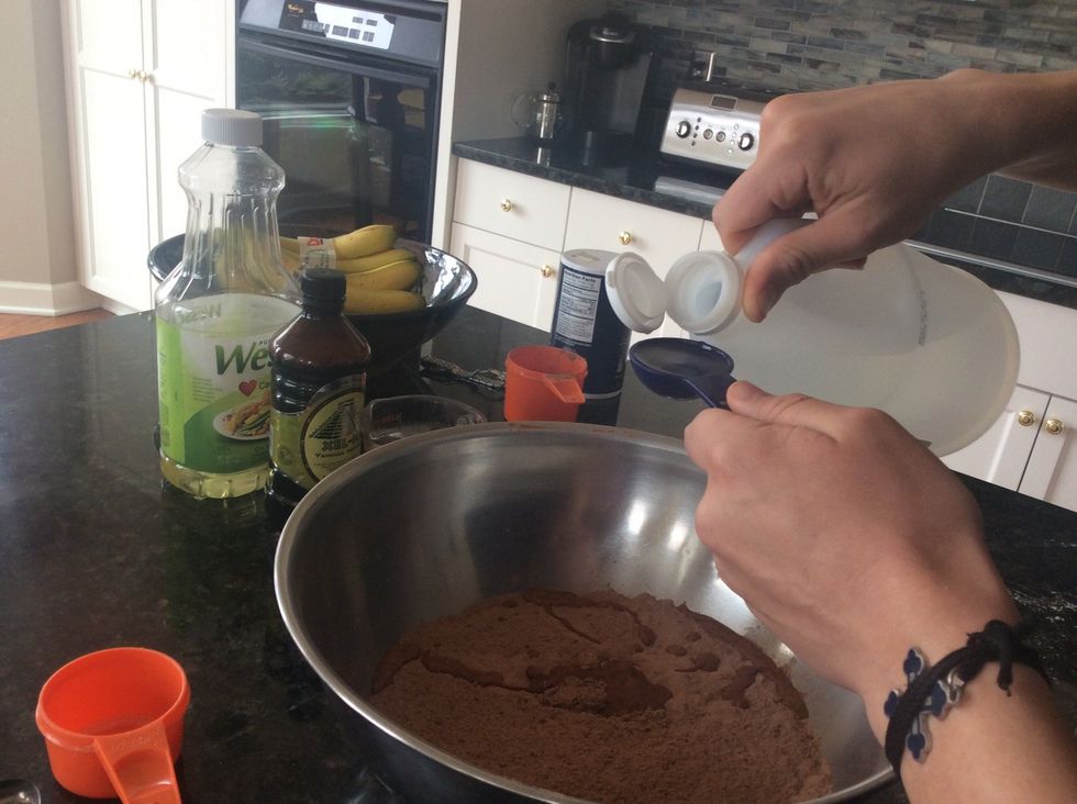 This is where we add all of the liquid ingredients. All of the liquids go directly into the large mixing bowl containing the dry ingredients. Add 2 Tablespoons of vinegar