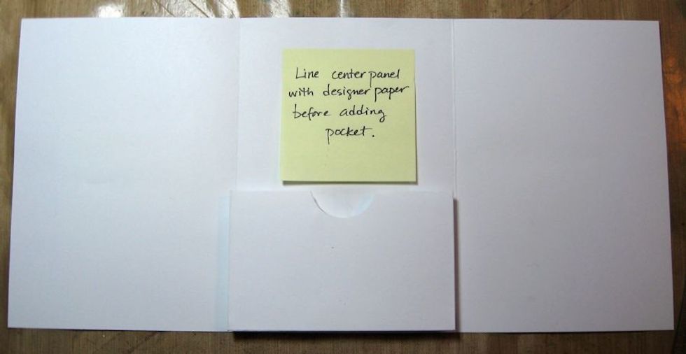 This is where you will place the pocket. Line the center panel with designer paper first. Line pocket front with patterned paper. Then glue the sides and bottom of the pocket. Center & glue in place.