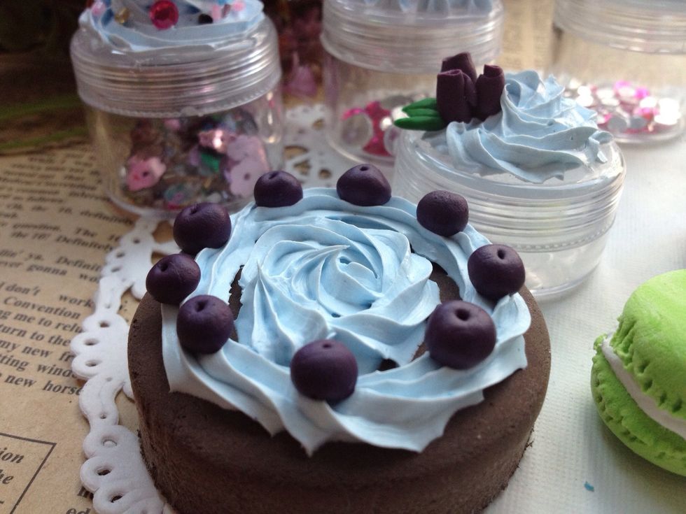 This is whipped cream clay applied on clay cake and then decorated by clay blueberry.