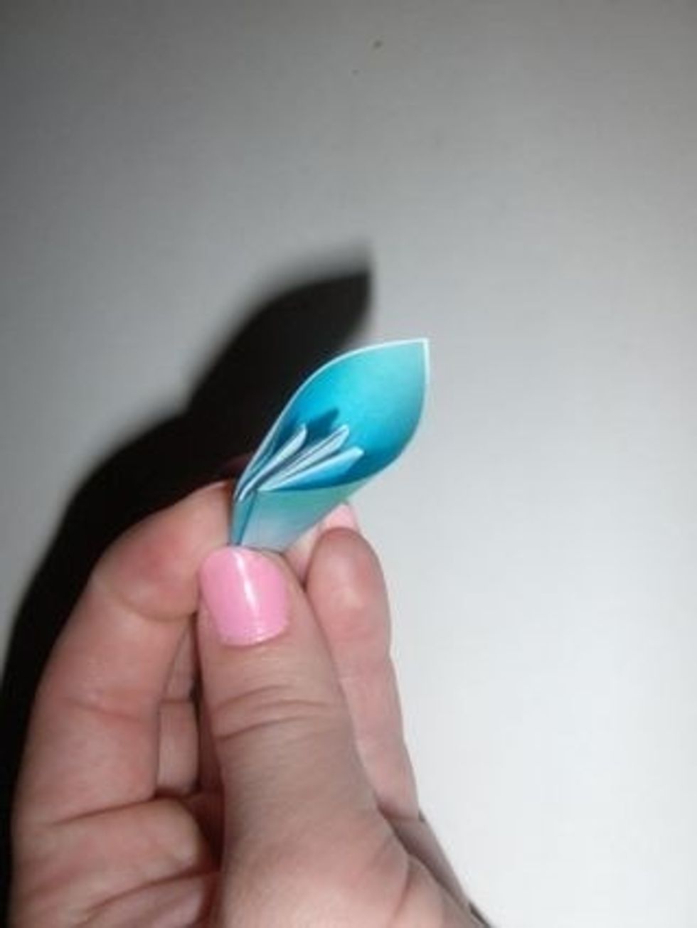 This is your first petal! You'll need to use the double stick tape and/or glue to attach the two edges.