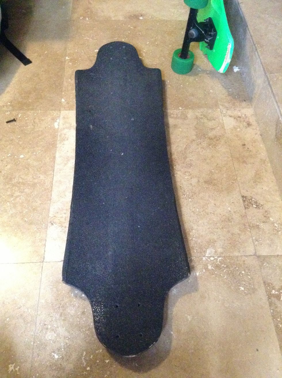 This is your skateboard/longboard deck. Some come with the grip tape applied out of the box. Others require that you purchase and apply your own. Most skate shops will do this for you.