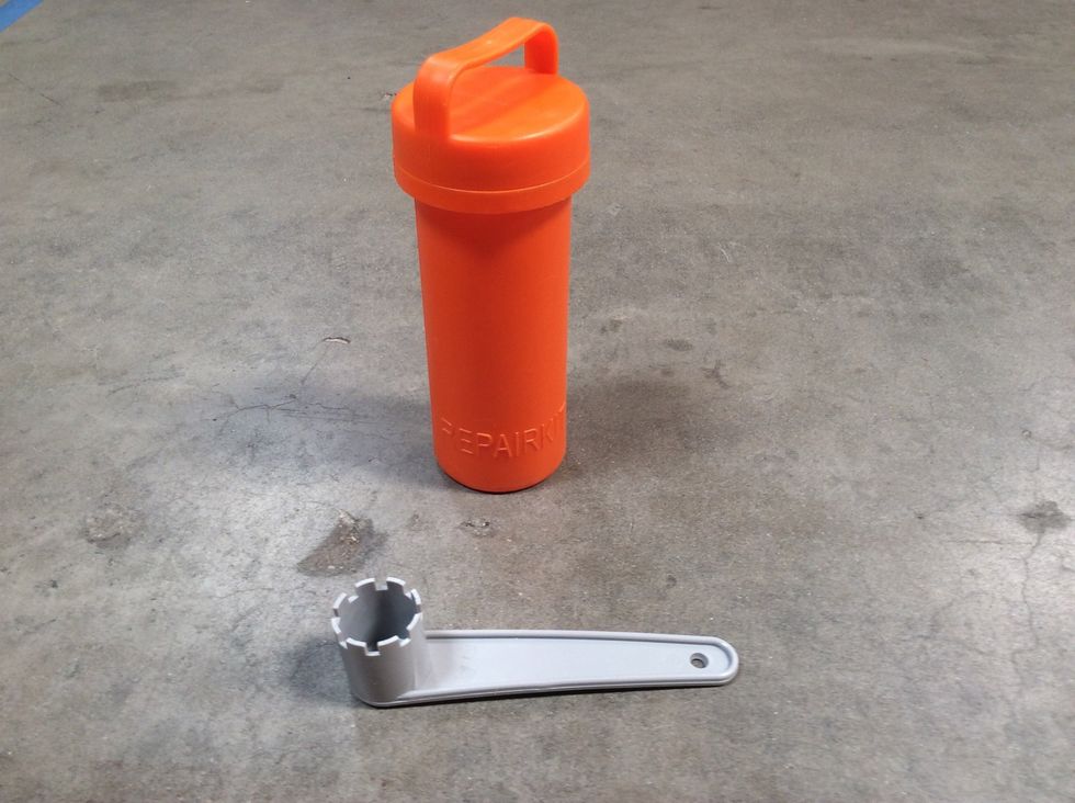 This is your valve wrench (grey), most likely found in your repair kit.