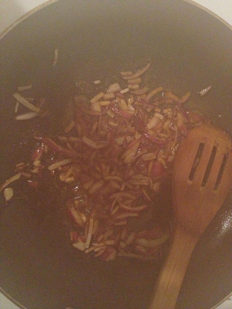 This looks dark!! It's red onion on oil and Indian spices - turmeric, chilli powder and cumin powder! Cook for 3 minutes