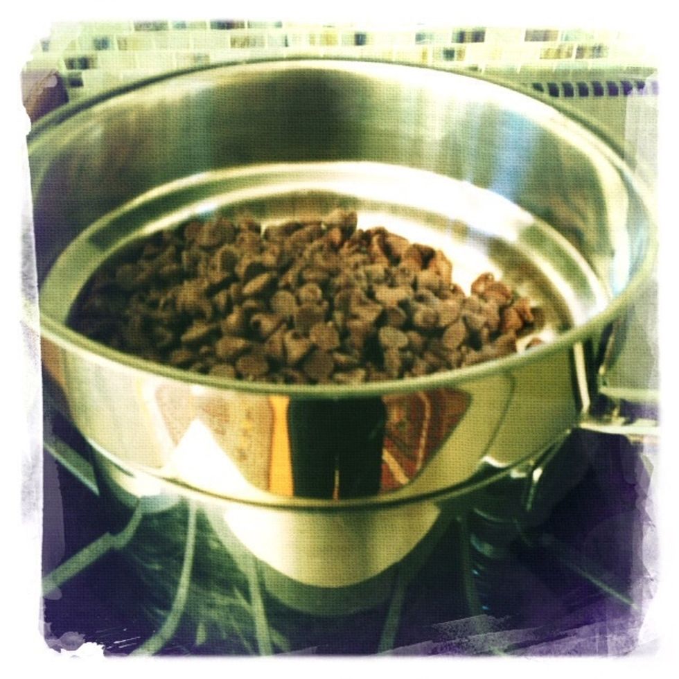 This magic recipie from my dear friend Maclin begins with Melting 9 ounces of Nestle\u2019s semi-sweet chocolate bits over hot water (double boiler!) with one stick butter cut into pieces.