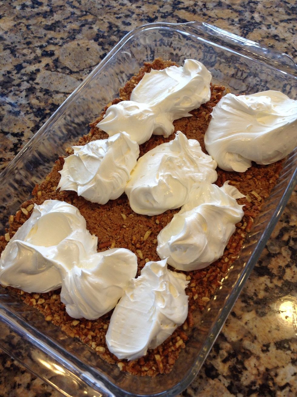 This part can be tricky. As you spread a top the pretzels make sure to push from top of whipped topping to cover. Because it will move the pretzel crust around if you aren't careful
