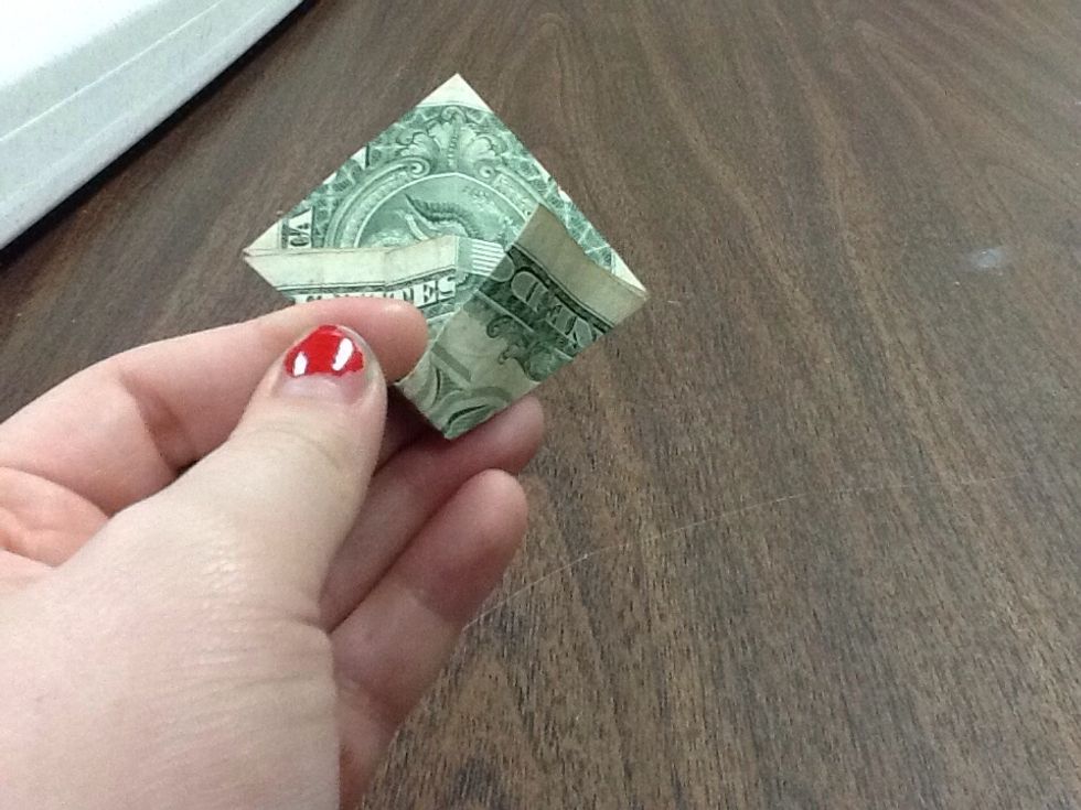 This part can get kind of tricky. Observe the picture carefully. Take the part underneath the fold you've created and pull it out, but not too much.