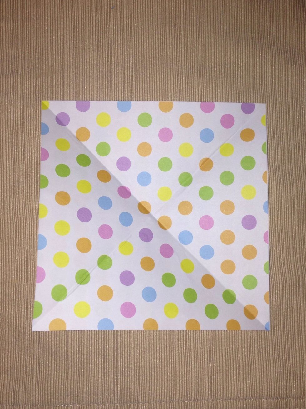 This should leave you with 2 creased diagonal lines intersecting each other.