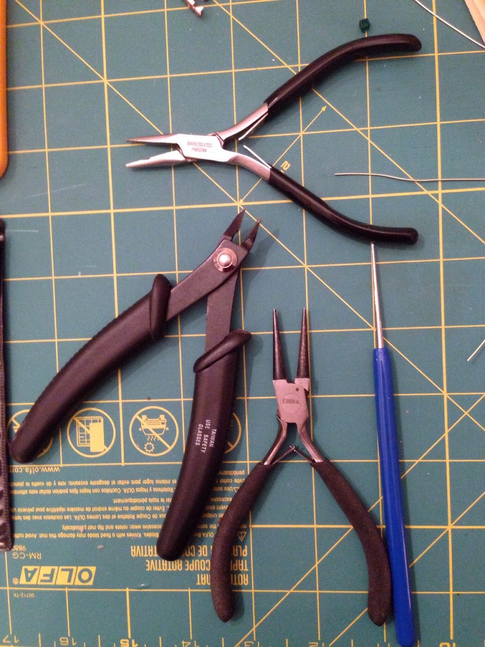 This shows some of the tools I used for this project--pliers, a wire cutter, and a beading awl.