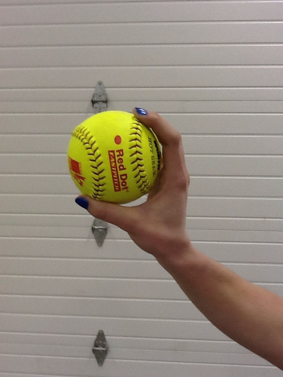 This shows the how to correctly place fingertip pressure on the seams and create space between the palm and the ball when the ball is at release point.