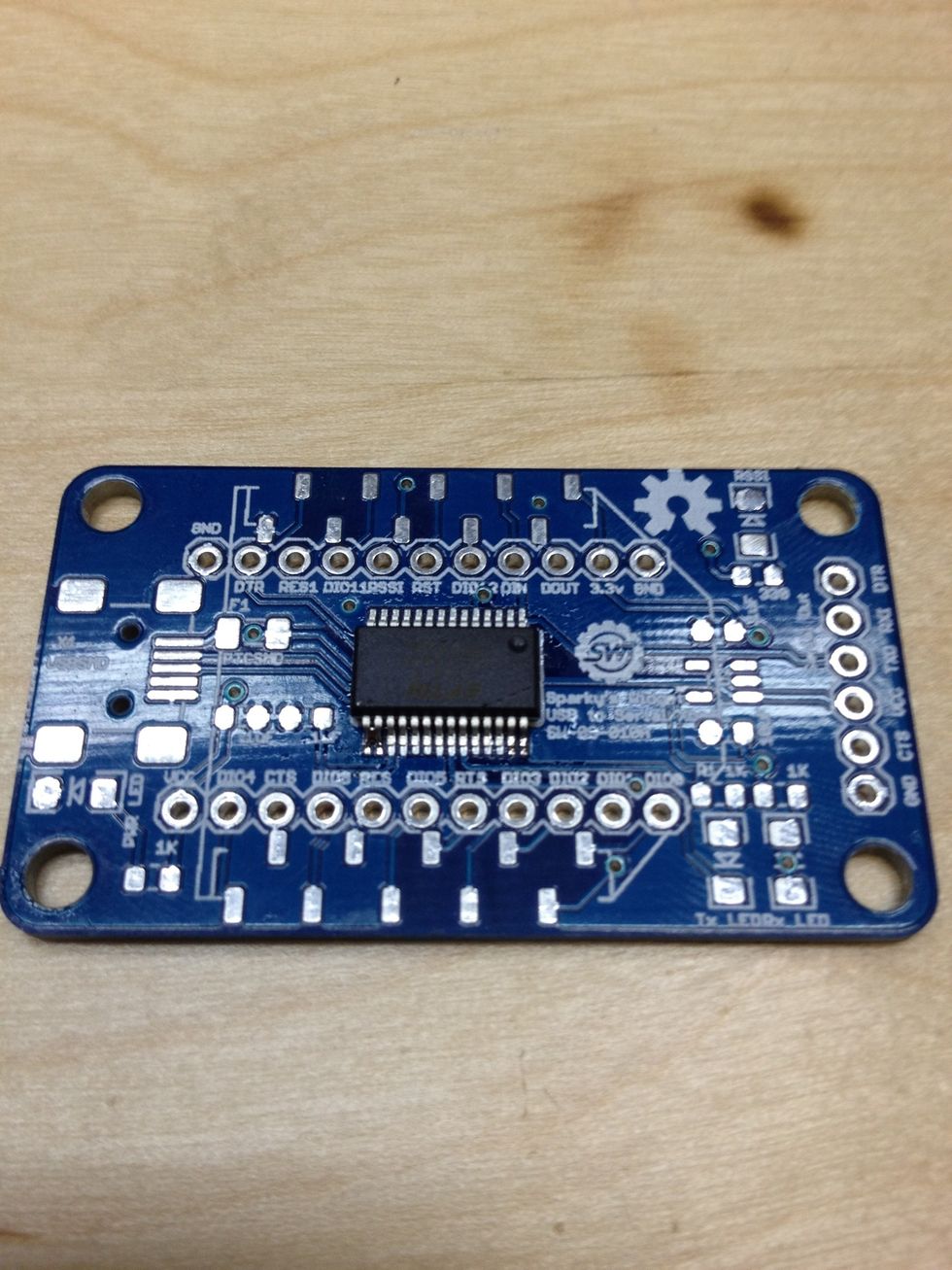 This side is tacked and the placement looks good. Let's go ahead and drag solder the other side. Now is a good time to put flux on the pins and pads again.