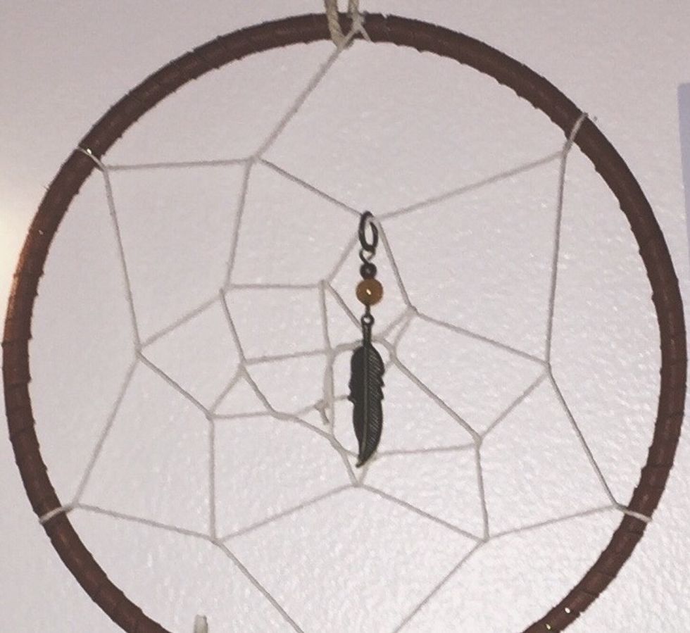 This step is optional but if you want, you can add a charm on one the loops.