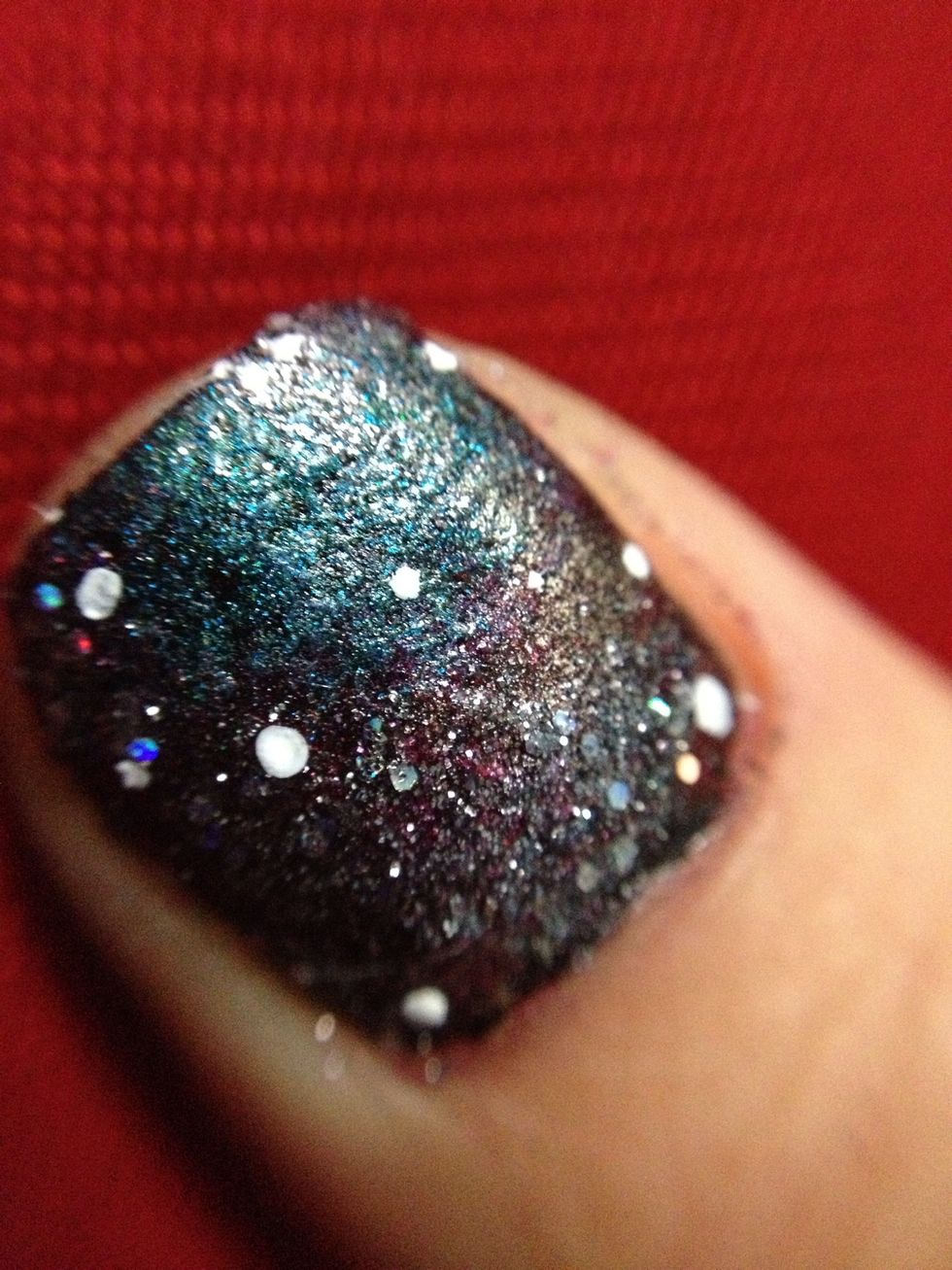 this step is optional but you can use a dotter to add stars. drop a couple drops of white nail polish and use a dotter or a toothpick to add it to your nail!