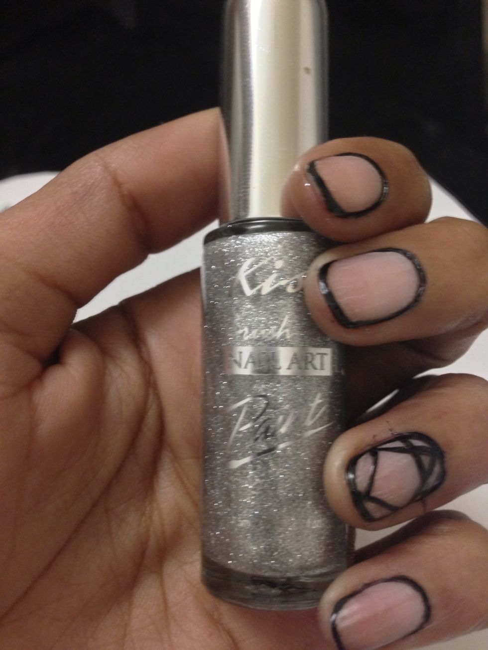 This step is optional. I'm going to go back in with some silver next to the black lines. I'm using Kiss Brush On Nail Art Paint for this as well.
