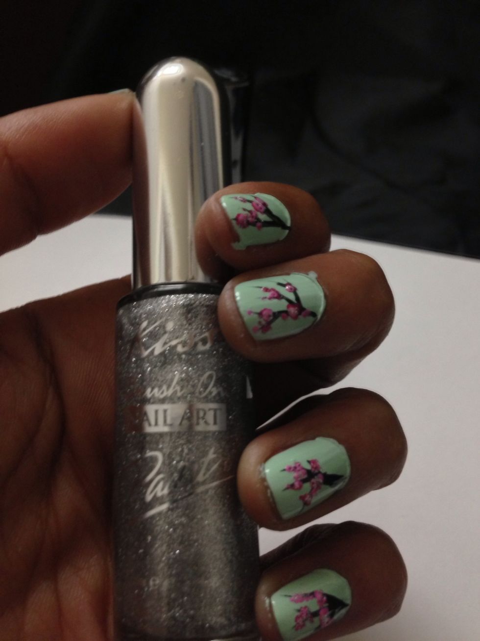 This step is totally optional! For a bit more dimension add a bit of silver right in the center of all your flowers. This is Silver Glitter by Kiss Brush On Nail Art Paint.